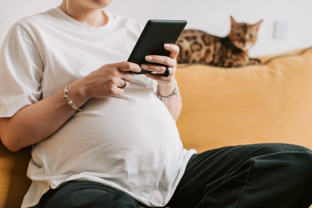 Mulher grávida segurando o tablet